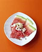 Slices of watermelon with feta and pink pepper