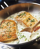 Fried salmon steaks with sour cream