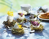Easter nests with eggshell vases and flowers