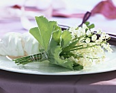 Posy of lilies-of-the-valley and meringue on a plate