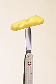 A piece of Emmental cheese on a Swiss pocket knife