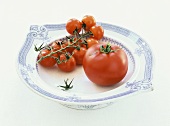 Two types of tomatoes on a plate