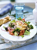 Greek salad with fried fish fillet