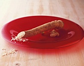 A horseradish root in a red dish