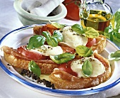 Crostini with Parma ham, tomatoes and mozzarella