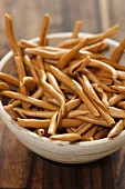Uncooked Filei Calabresi pasta in small wooden bowl