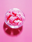 Raspberry sweets in small glass bowl