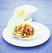 Spicy shrimps with cashew nuts in lettuce leaf