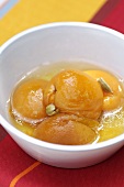 Poached peaches in a small bowl