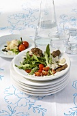 Fried beef fillet with rocket and tomato salad