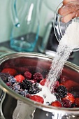 Putting sugar on berries in a pan
