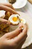 Eating a boiled egg and soldiers (strips of toast)