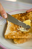 Buttering toast
