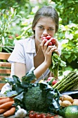 Young woman holding a bunch of radishes