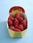 Fresh raspberries in a cardboard punnet