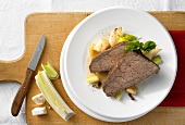 Sauerbraten (marinated beef) on a bed of vegetables