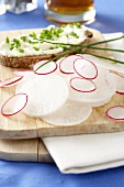 Large and small radishes and bread and quark with chives