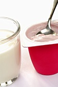 Natural yoghurt in glass and fruit yoghurt with spoon