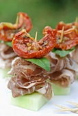 Coppa appetisers with cucumber and dried tomatoes in oil