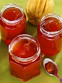 Three open jars of quince jelly