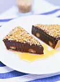 Two slices of chocolate tart with macadamia nuts