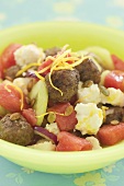 Fruity summer salad with meatballs