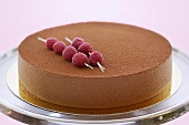 Chocolate mousse cake with skewered raspberries