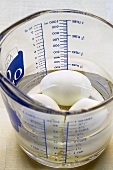 Boiled eggs in water in a measuring jug