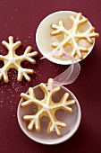 Three snowflake cookies and china bowls