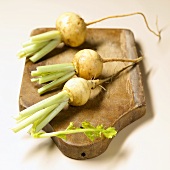 Three Teltow turnips on a wooden board