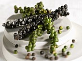 Bunches of black and green pepper