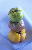 Three tomatoes in a pile