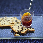 A glass of punch and fruit cake