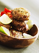 Meat patties with lime wedges