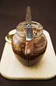 Chocolate spread in jar with knife