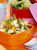 Pasta salad with vegetables and feta for a picnic