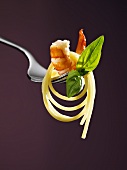Spaghetti with shrimp and basil on a fork