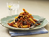 Penne alla puttanesca (Pasta with tomatoes, capers, olives)
