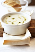 Creamed potato soup with pesto in soup bowl
