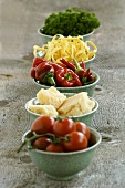 Various pasta ingredients in small bowls