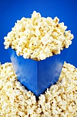 Popcorn in and around blue carton
