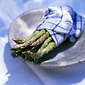 Green asparagus wrapped in a tea towel