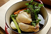Chicken with root vegetables in large pan