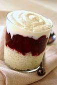 Rice pudding and plum compote in layers in a glass