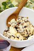 Christmas pudding ice cream in small bowl with wooden spoon