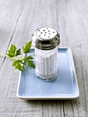 Full salt shaker in a dish