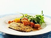 Fried salmon fillet with mustard crust and tomato salad