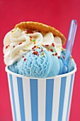 Blue ice cream in tub with sugar sprinkles