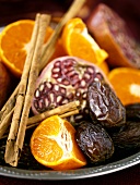 Mandarin oranges, dates, pomegranate and cinnamon sticks