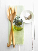 Olive oil, salt and pepper and salad servers